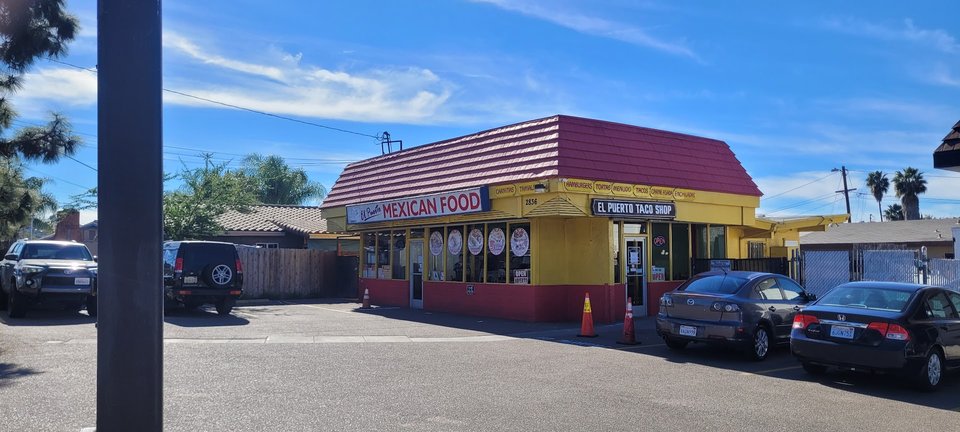 Counter-serve taco shop interior with simple seating.