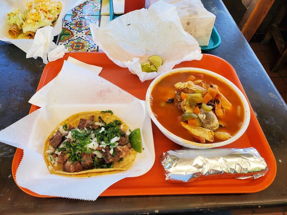 Casual eatery with a large wall menu.
