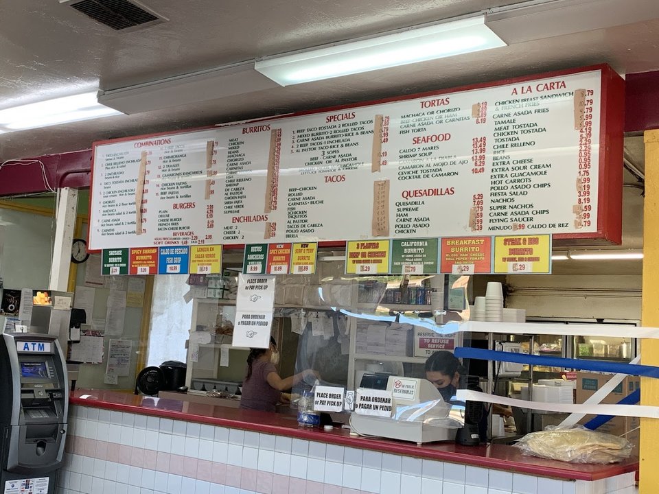 Casual eatery with a large wall menu.