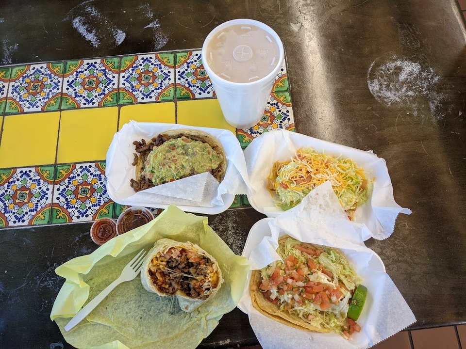 Mexican favorites listed on a large menu board.