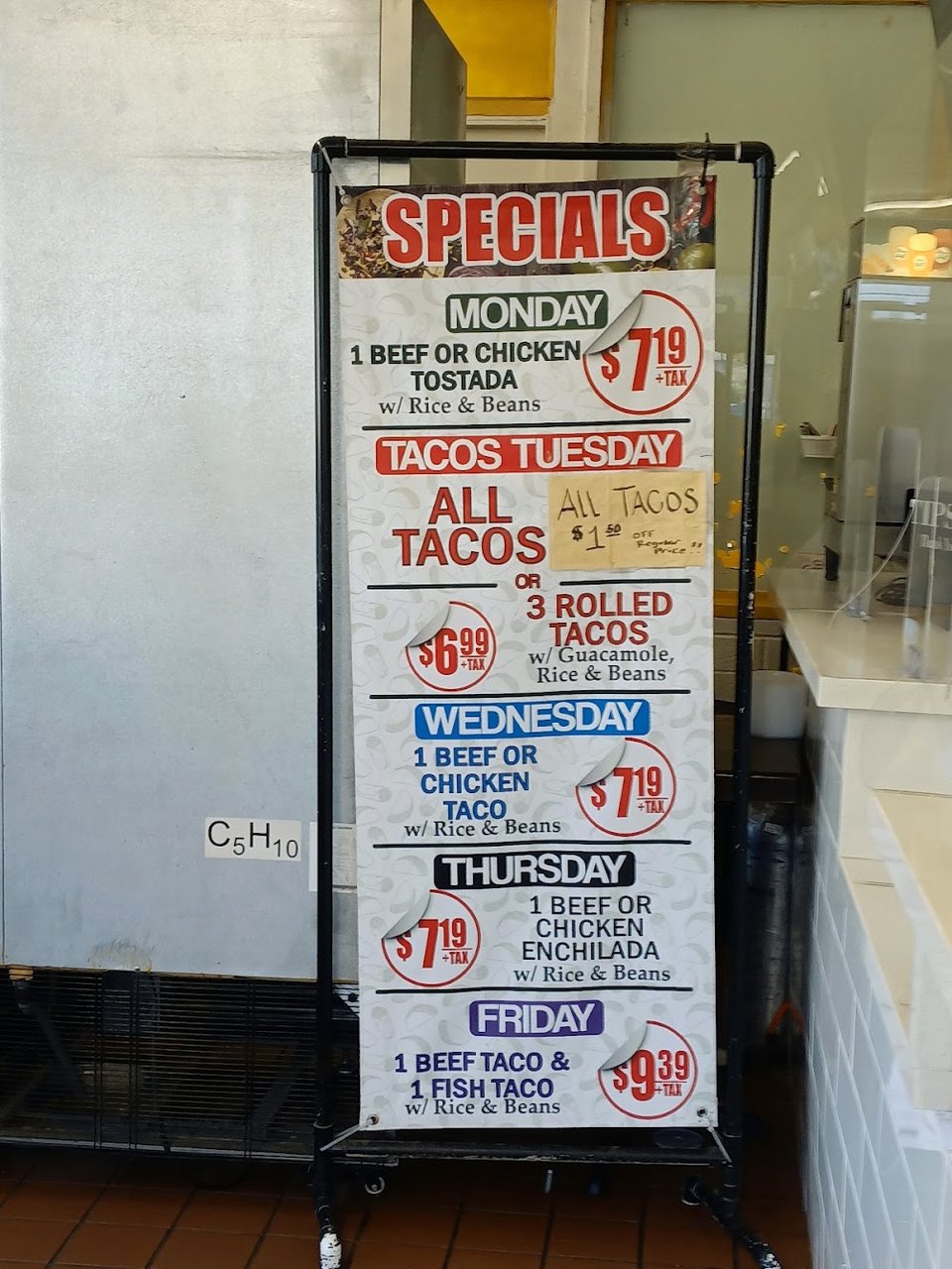 Mexican favorites listed on a large menu board.